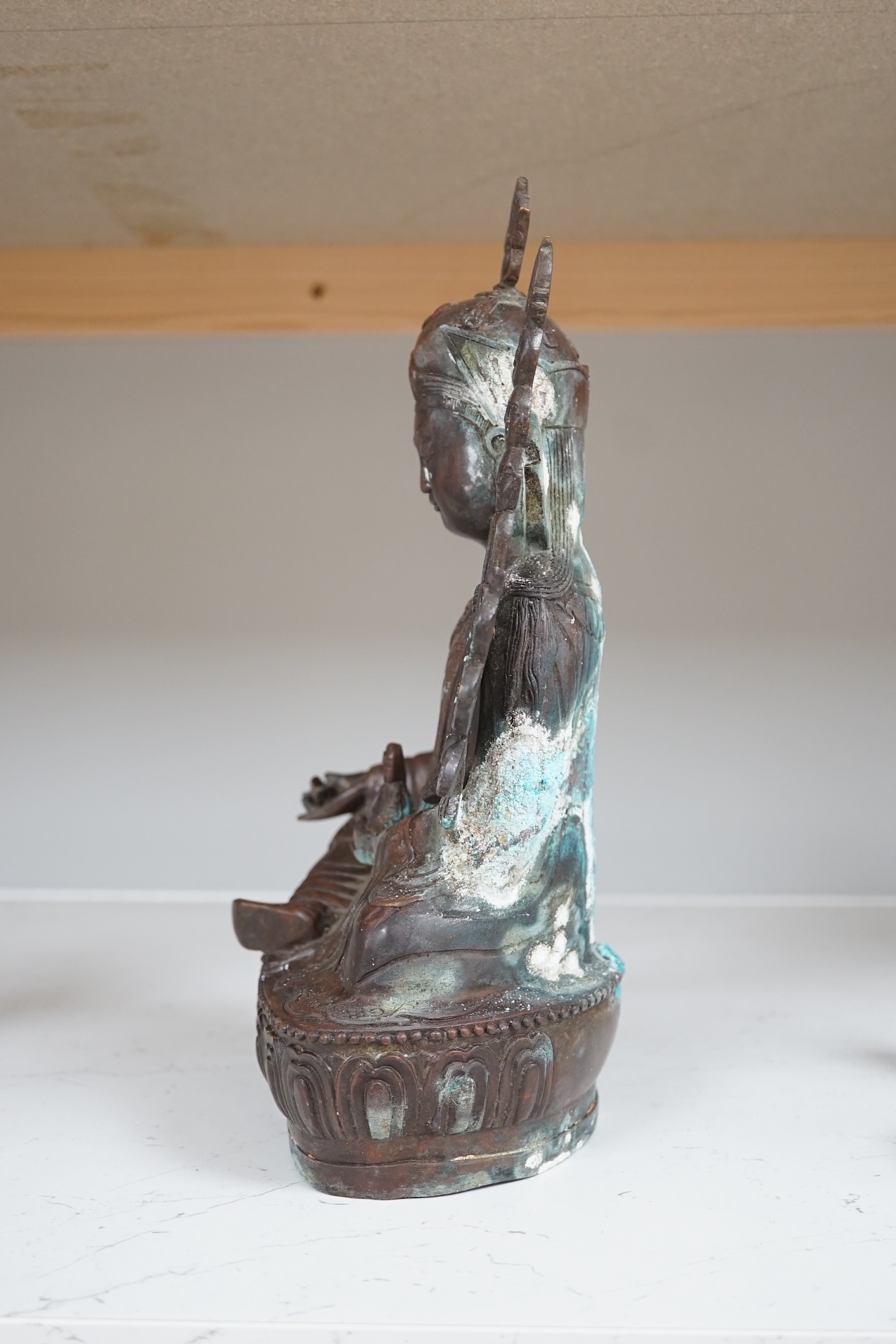 A Tibetan bronze Padmasambhava Buddhist figure, 29.5cm high. Condition - poor to fair.